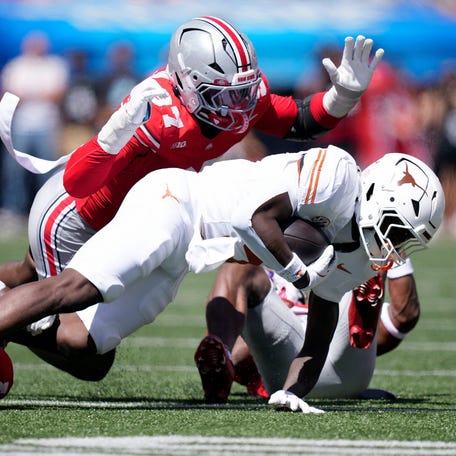 Ohio State defensive end Kenyatta Jackson Jr. (97) tackles Texas running back Quintrevion Wisner (5) on a run in the third quarter of their game at Ohio Stadium in Columbus, Ohio on Aug 30, 2025.