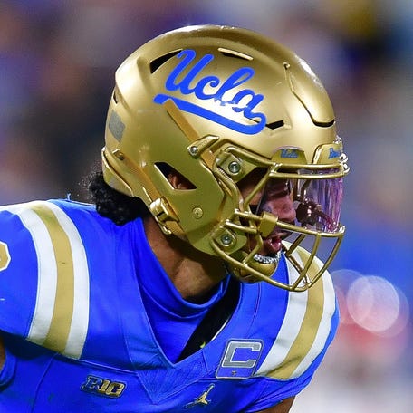 UCLA Bruins quarterback Nico Iamaleava (9) runs the ball as offensive lineman Sam Yoon (64) provides coverage against Utah Utes linebacker Lander Barton (8) during the second half at Rose Bowl.