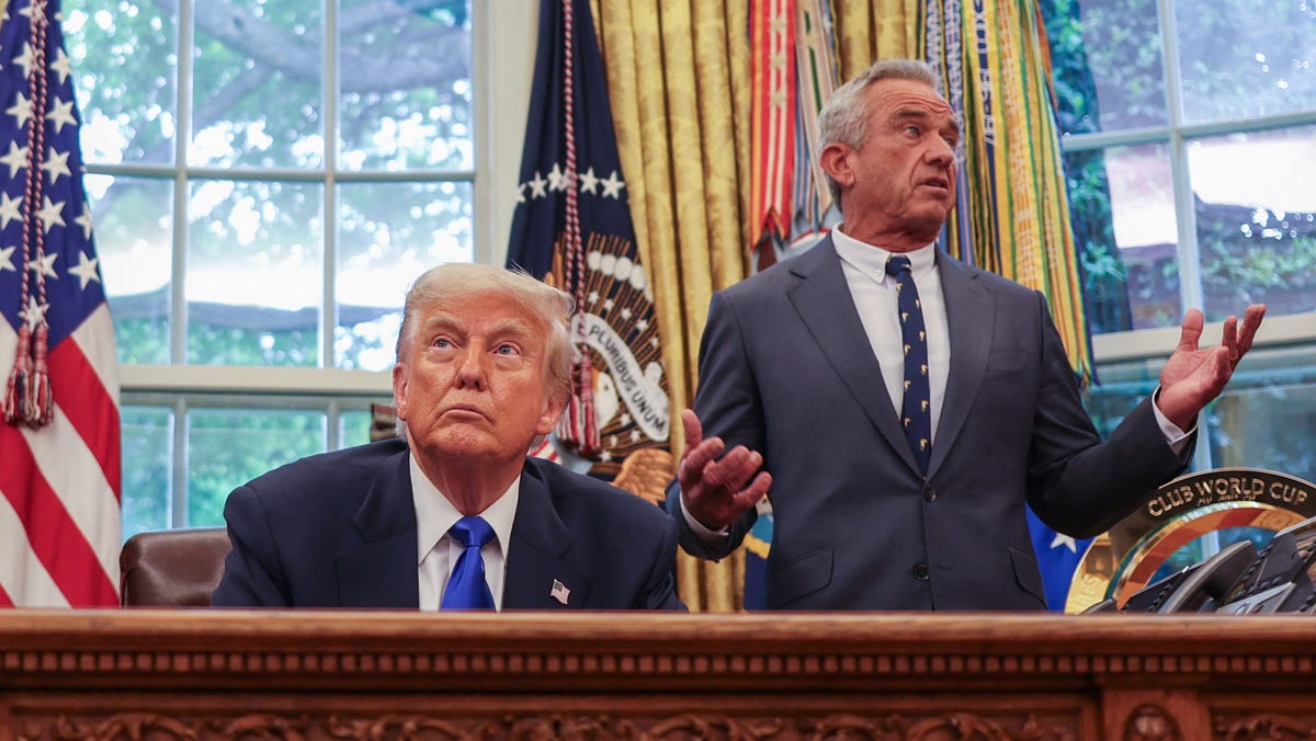 Secretary of Health and Human Services Robert F. Kennedy Jr. (R) speaks US President Donald Trump during an executive orders signing event in the Oval Office of the White House in Washington, DC, on May 5, 2025.