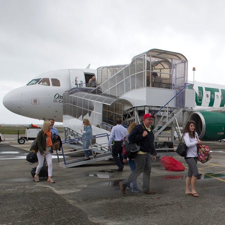 Passengers arriving from Philadelphia on Frontier Airlines Flight 1079 walk toward the new terminal at the Northeast Florida Regional Airport in St. Augustine after the airline's inaugural flight between the two cities on Friday, April 15, 2016. Frontier stopped flying to the city in 2017.