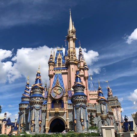 Cinderella Castle had a makeover, with new royal colors and embellishments, as Magic Kingdom turns 50 years old. Guests from around the world are expected for Walt Disney World's 18-month celebration at WDW's four parks.