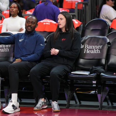 Sep 2, 2025; Phoenix, Arizona, USA; Indiana Fever guard Caitlin Clark (22) talks to coach Keith Porter before a game against the Phoenix Mercury at PHX Arena. Mandatory Credit: Rick Scuteri-Imagn Images