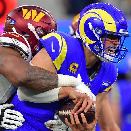 Dec 17, 2023; Inglewood, California, USA; Washington Commanders defensive tackle Daron Payne (94) brings down Los Angeles Rams quarterback Matthew Stafford (9) during the second half at SoFi Stadium. Mandatory Credit: Gary A. Vasquez-USA TODAY Sports