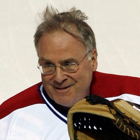 Former Montreal Canadiens goaltender Ken Dryden waves to the crowd during the team's 100th anniversary ceremony in Montreal on Dec. 4, 2009.