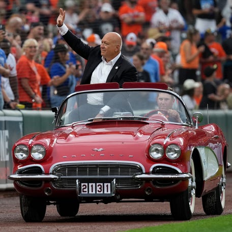 Cal Ripken Jr. waves to fans as he rides around the warning track before his 2,131 ceremony.