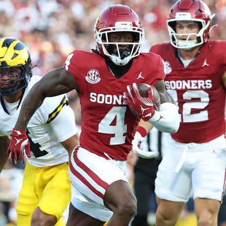 Oklahoma wide receiver Deion Burks (4) runs for a touchdown after a catch against Michigan during their game at Gaylord Family-Oklahoma Memorial Stadium.