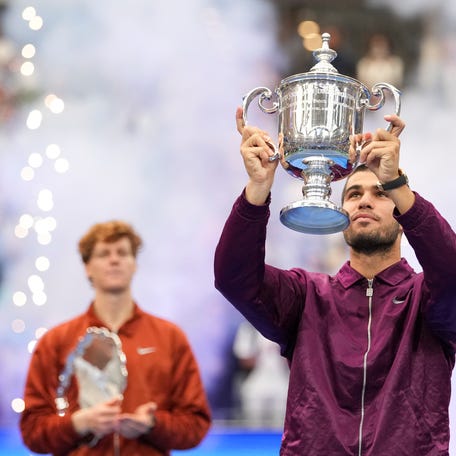 Carlos Alcaraz (ESP) holds the trophy after defeating Jannik Sinner (ITA) in the final of mens singles at Billie Jean King National Tennis Center.