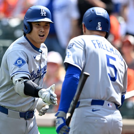 Shohei Ohtani celebrates a home run with Freddie Freeman.