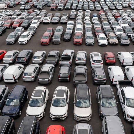 Fleet of vehicles parked in a car dealership.