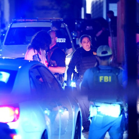 Washington, DC, police officers work with federal law enforcement agencies to make an arrest in the Columbia Heights neighborhood on Sept. 7, 2025. A day later, Attorney General Pam Bondi said 214 illegal guns have been seized and 2,120 arrests have been made in the month since the Trump administration took over the city.