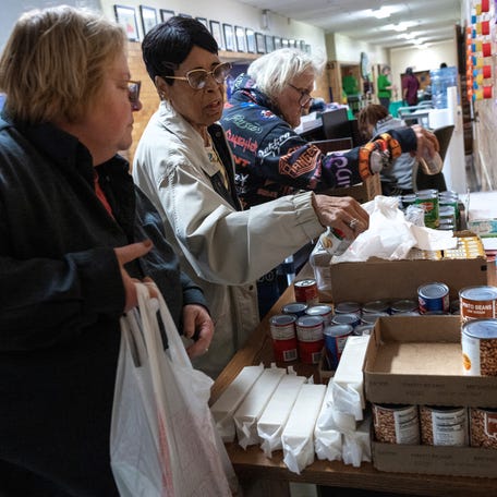 Senior citizens collect canned goods from a food pantry at the Roosevelt Community Center in Charleston, West Virginia, as food banks say they will have less food to distribute because of federal funding cuts and pauses by the Trump administration, March 19, 2025.