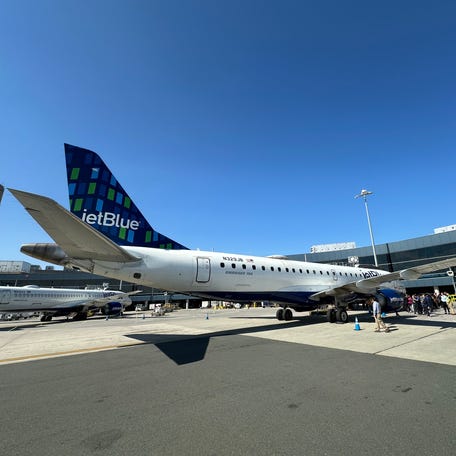 JetBlue's last Embraer E190, "My Other Ride Is A JetBlue A320" at the gate after its final revenue flight.