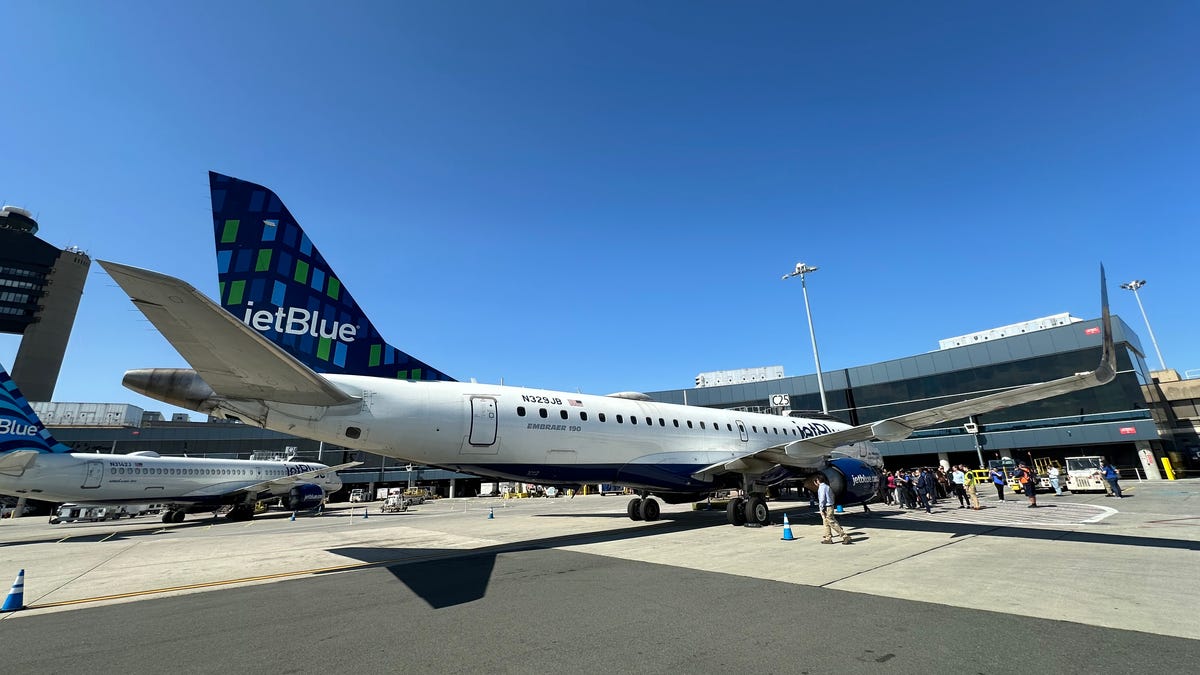 JetBlue's last Embraer E190, "My Other Ride Is A JetBlue A320" at the gate after its final revenue flight.