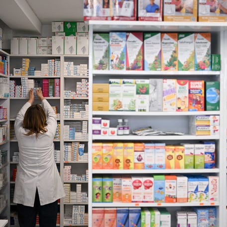 A pharmacy owner arranges medicines at a pharmacy in Pristina on March 27, 2025. The antidiabetic medicine of Ozempic is surging in Kosovo as a quick-fix weight loss solution, driving up demand and sending prices soaring, despite warnings about possible side effects of the Diabetes drug. (Photo by Armend NIMANI / AFP) (Photo by ARMEND NIMANI/AFP via Getty Images)