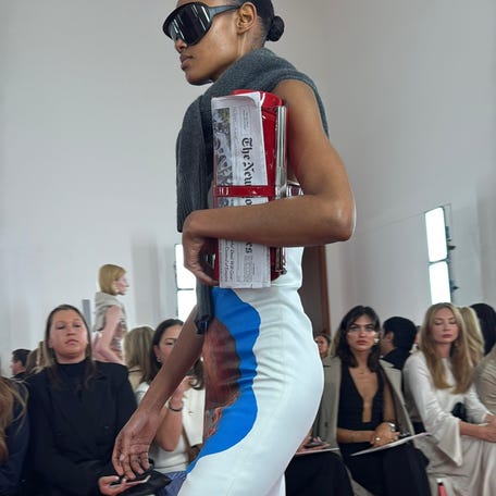 Models at Brandon Maxwell's 10th anniversary show during New York Fashion Week carried newspapers down the runway on Sept. 9, 2025.