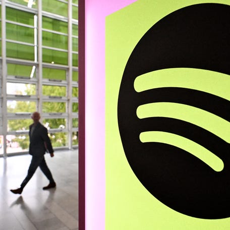 A person walks past a banner with an Spotify logo at the Frankfurt book fair on Oct. 17, 2024 in Frankfurt am Main, western Germany.