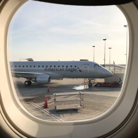 An American Eagle Embraer 175 aircraft is seen on the tarmac through a plane window at LAX in Los Angeles, California, U.S., January 10, 2018. REUTERS/Lucy Nicholson