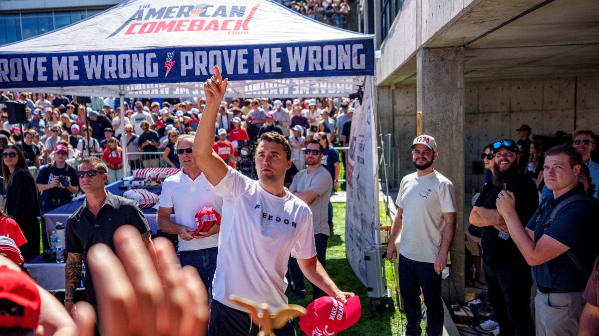 Conservative activist Charlie Kirk throws hats to the crowd shortly before he was fatally shot Sept. 10, 2025, at a Utah Valley University speaking event in Orem.