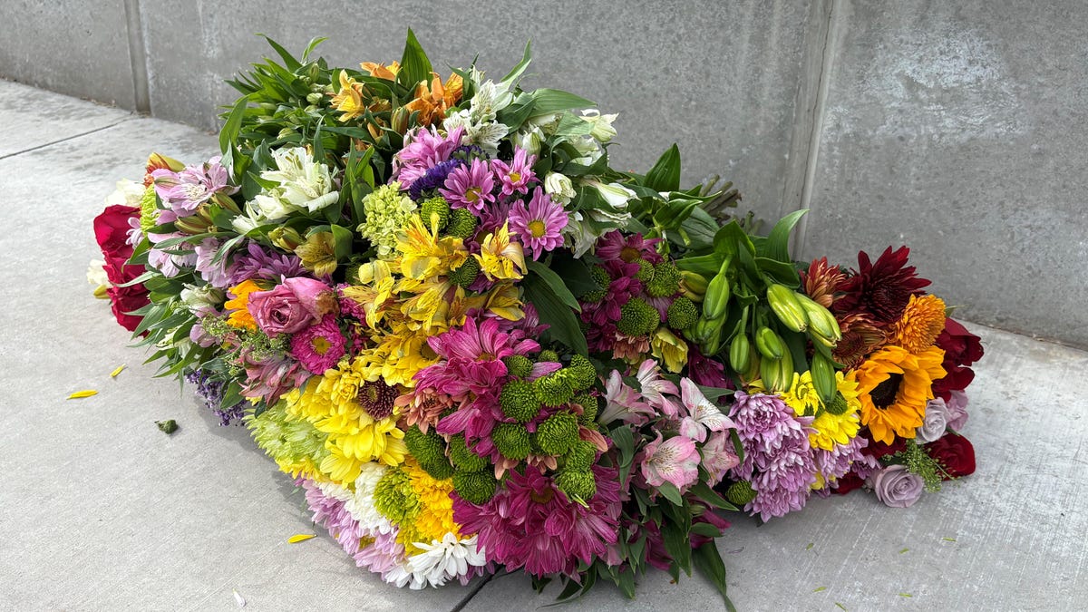 A bouquet of flowers was placed in front of the Utah Valley University sign on Sept. 10, 2025, hours after the fatal shooting of Charlie Kirk.