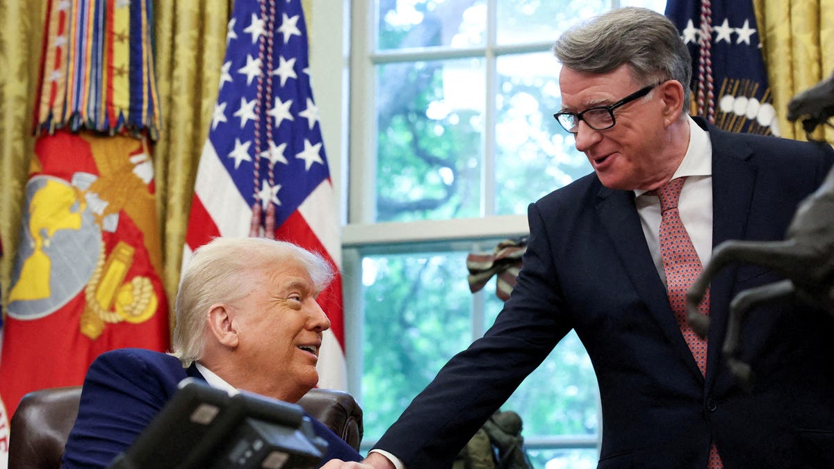 U.S. President Donald Trump, left, shakes hands with Britain's ambassador to the United States, Peter Mandelson, in the Oval Office at the White House in Washington, D.C., on May 8, 2025.
