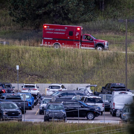 West Metro paramedics drive past as police stand at Evergreen High School, where a shooting occurred earlier in the day, on September 10, 2025.