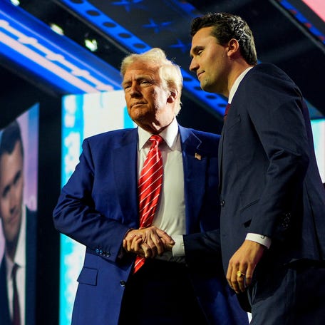 Republican presidential nominee Donald Trump, running for reelection in 2024, shakes hands with Turning Point USA cofounder Charlie Kirk in Phoenix.