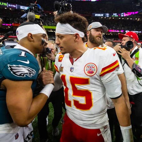Feb 9, 2025; New Orleans, LA, USA; Philadelphia Eagles quarterback Jalen Hurts (1) greets Kansas City Chiefs quarterback Patrick Mahomes (15) following Super Bowl LIX at Ceasars Superdome. Mandatory Credit: Mark J. Rebilas-Imagn Images