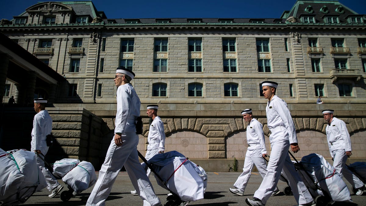 Incoming plebes walk with their newly issued gear during Induction Day at the U.S. Naval Academy in Annapolis, Maryland June 27, 2019. REUTERS/Al Drago