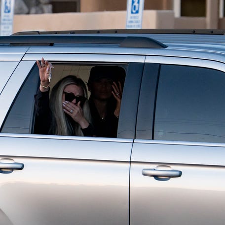 Erika Kirk waves to supporters who gathered to watch as a motorcade escorted the body of Charlie Kirk to Hansen Mortuary Chapel in Phoenix on Sept. 11, 2025.