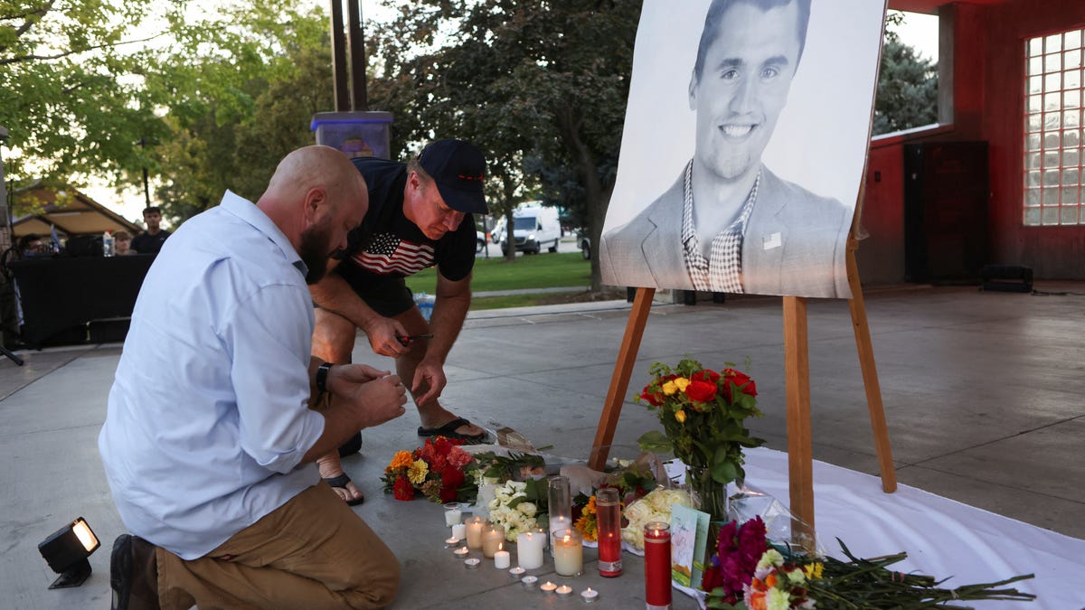 People are pictured at a vigil after Charlie Kirk was fatally shot during an event at Utah Valley University.