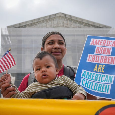 Olga Urbina and her child Ares Webster from Baltimore, MD, demonstrate outside the Supreme Court before justices hears oral arguments in Trump v. CASA, Inc. At issue in the case is if the Supreme Court should stay the district courts' nationwide preliminary injunctions on the Trump administration's executive order ending birthright citizenship.