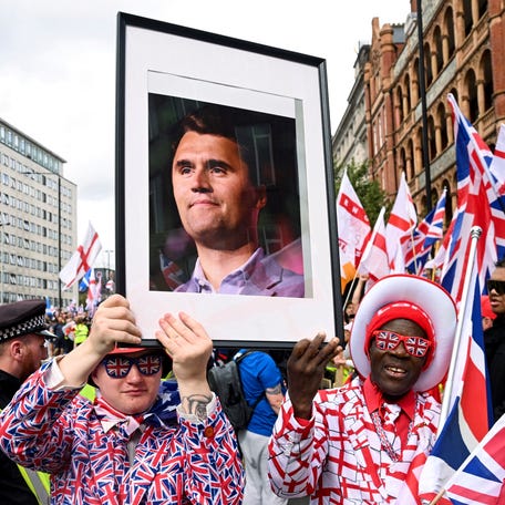 Protesters hold a picture of U.S. conservative activist Charlie Kirk, who was fatally shot while speaking at an event at Utah Valley University, on the day of an anti-immigration rally organized by British anti-immigration activist Stephen Yaxley-Lennon, also known as Tommy Robinson, in London, Britain, September 13, 2025.