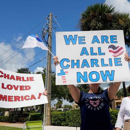 Community members gather at an intersection in Indian River County just west of Vero Beach, Florida, for a Charlie Kirk flag wave gathering, Sept. 13, 2025, to honor the 31-year-old activist who was killed by a single gunshot while speaking in front of some 3,000 people as part of his 'American Comeback Tour' at Utah Valley University.