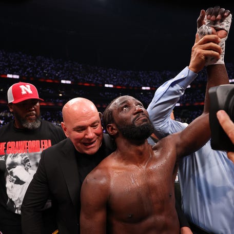 Dana White, CEO and president of the UFC, awards the belt to Terence Crawford after Crawford won by unanimous decision against Canelo Alvarez.