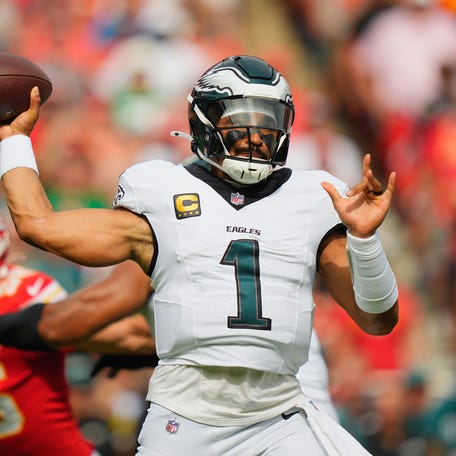 Sep 14, 2025; Kansas City, Missouri, USA; Philadelphia Eagles quarterback Jalen Hurts (1) passes the ball against the Kansas City Chiefs during the first quarter of the game at GEHA Field at Arrowhead Stadium.