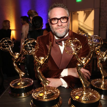 Seth Rogen poses with his "The Studio" awards at the 77th Emmy Awards on Sept. 14.