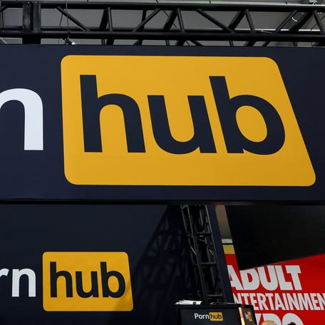 Signs are displayed at the Pornhub booth at the 2024 AVN Adult Entertainment Expo at Resorts World Las Vegas on January 25, 2024 in Las Vegas, Nevada.