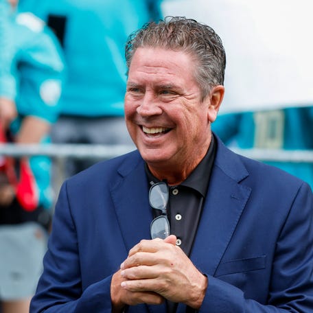 Former Miami Dolphins quarterback Dan Marino talks with fans before a 2024 game between the Dolphins and Seahawks in Seattle.
