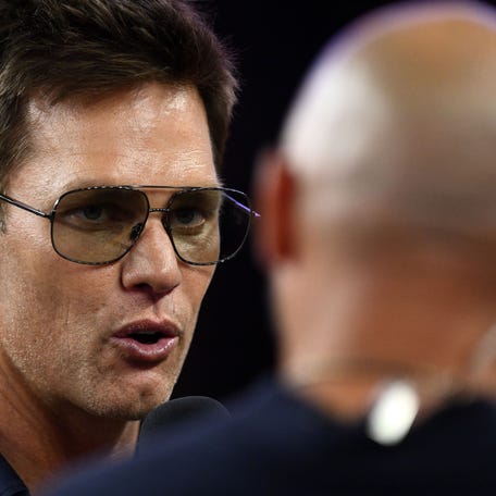 Aug 8, 2025; Foxborough, Massachusetts, USA; Retired Hall of Fame New England Patriot player Tom Brady talks with Brian Hoyer during the first half of a game against the Washington Commanders at Gillette Stadium. Mandatory Credit: Brian Fluharty-Imagn Images