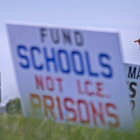 Malachi Kamler, from Ft. Wayne, joins protesters Tuesday, Aug. 12, 2025 outside Miami Correctional Facility in Bunker Hill, Ind. They protested against plans to use Miami Correctional as an ICE detention center.