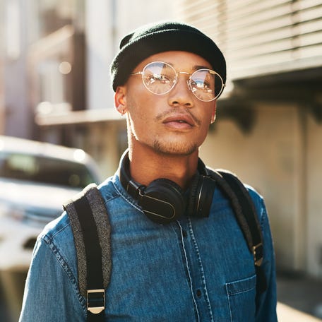 Cropped shot of a handsome young man walking through the city