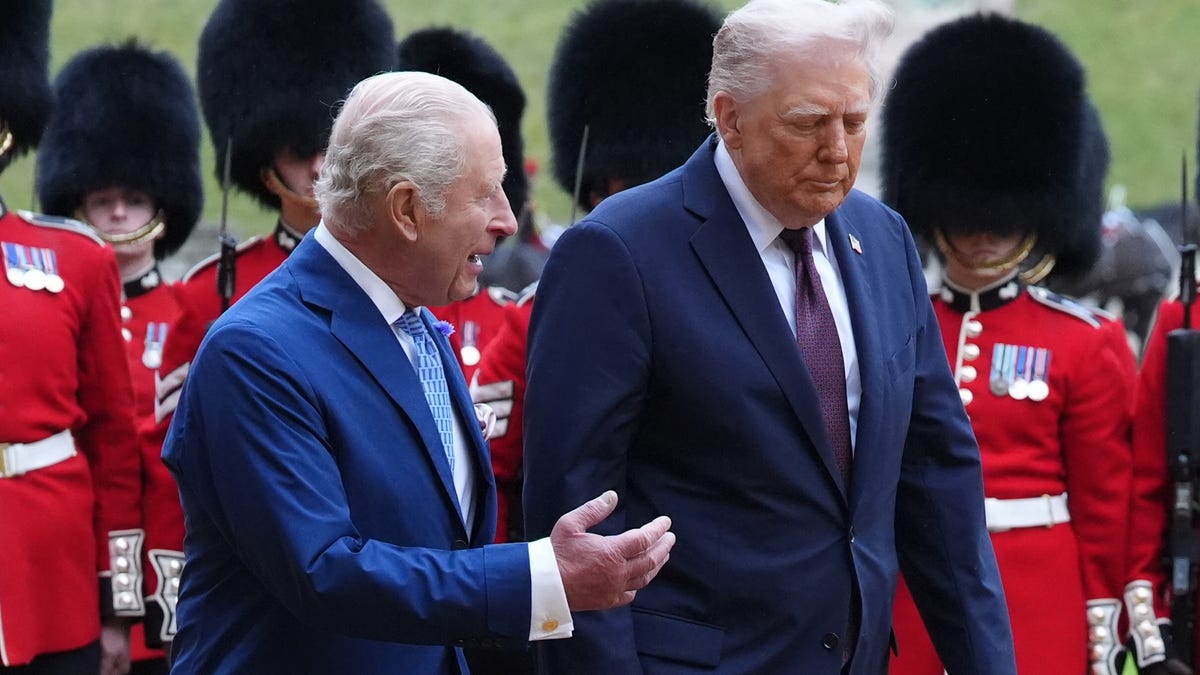President Donald Trump and King Charles III (L) review the guard of honour during the ceremonial welcome during the State visit by the President of the United States of America on September 17, 2025 in Windsor, England.