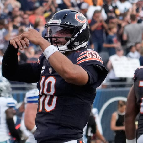 Sep 21, 2025; Chicago, Illinois, USA; Chicago Bears quarterback Caleb Williams (18) gestures after throwing a touchdown against the Dallas Cowboys during the second half at Soldier Field. Mandatory Credit: David Banks-Imagn Images