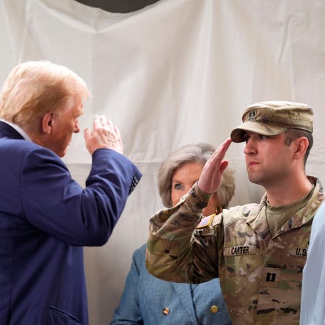 Former President Donald Trump greets members of the Georgia National guard during his visit to Evans, Ga., on Friday, Oct. 4, 2024. Trump came to get a briefing on Hurricane Helene and speak to supporters.