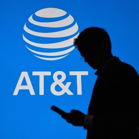 A visitor walks past US multinational telecommunications AT&T logo at the Mobile World Congress in Barcelona on February 27, 2023.