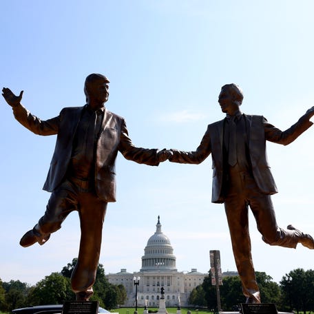 A statue depicting U.S. President Donald Trump and Jeffrey Epstein holding hands is seen near the U.S. Capitol on Sept. 23, 2025, in Washington, D.C. A plaque below the figures states "In Honor of Friendship Month."