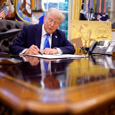 President Donald Trump signs an executive order in the Oval Office at the White House on September 19, 2025. Trump signed two executive orders, introducing a $100,000 fee for H-1B visas and establishing the "Trump Gold Card," a visa program that allows a pathway to U.S. citizenship for a $1 million investment in the United States.