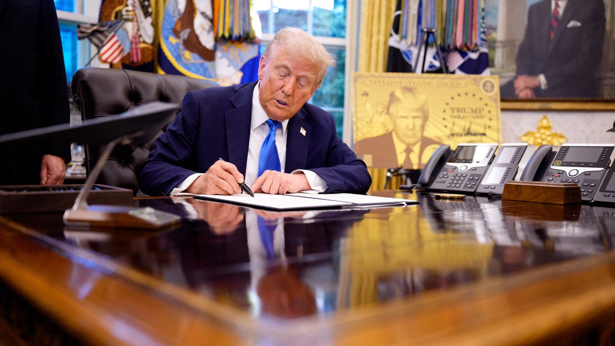 President Donald Trump signs an executive order in the Oval Office at the White House on September 19, 2025. Trump signed two executive orders, introducing a $100,000 fee for H-1B visas and establishing the "Trump Gold Card," a visa program that allows a pathway to U.S. citizenship for a $1 million investment in the United States.