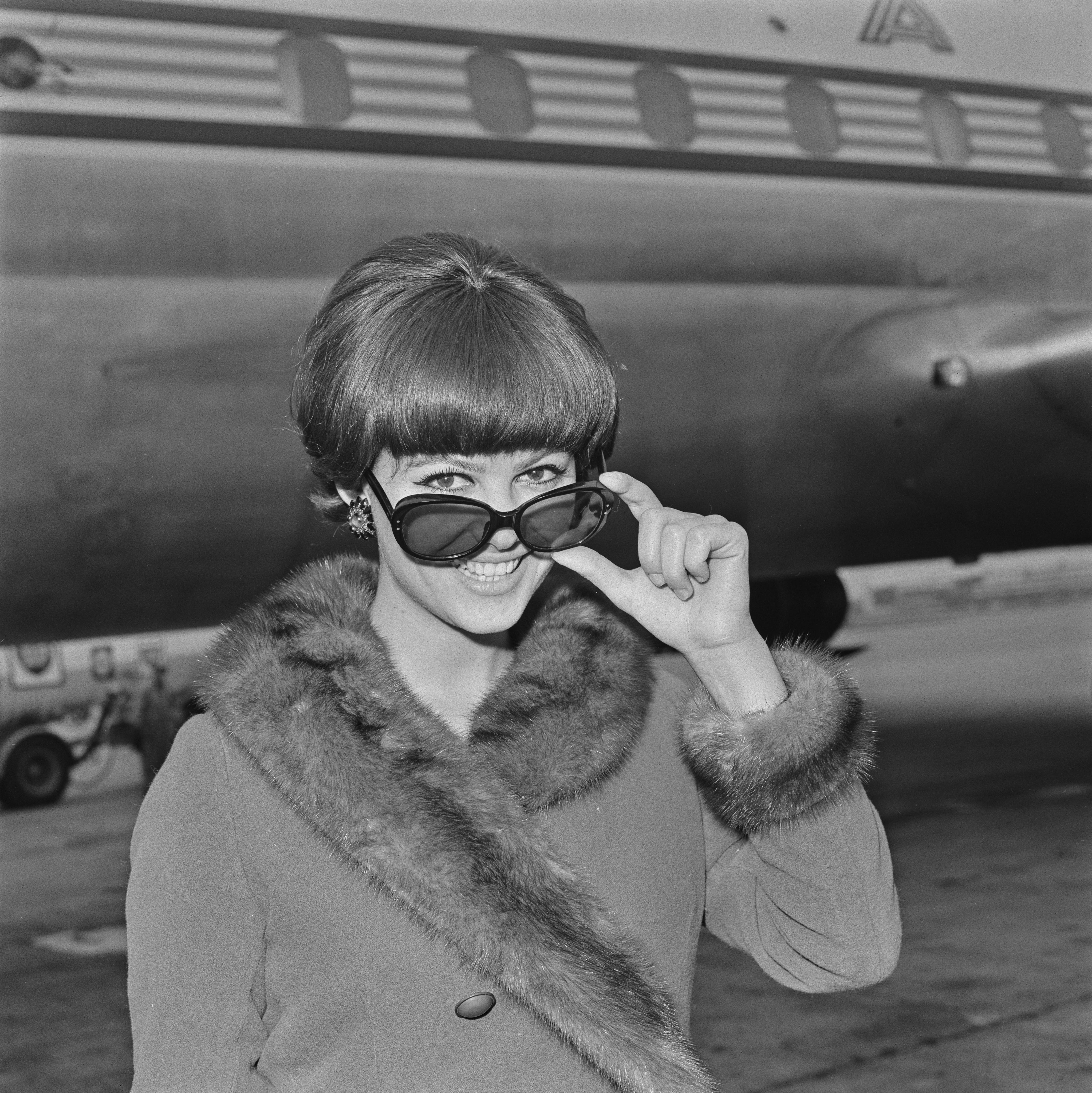 <p style="margin: 0;">Cardinale at a UK airport on Nov. 19, 1964.</p>