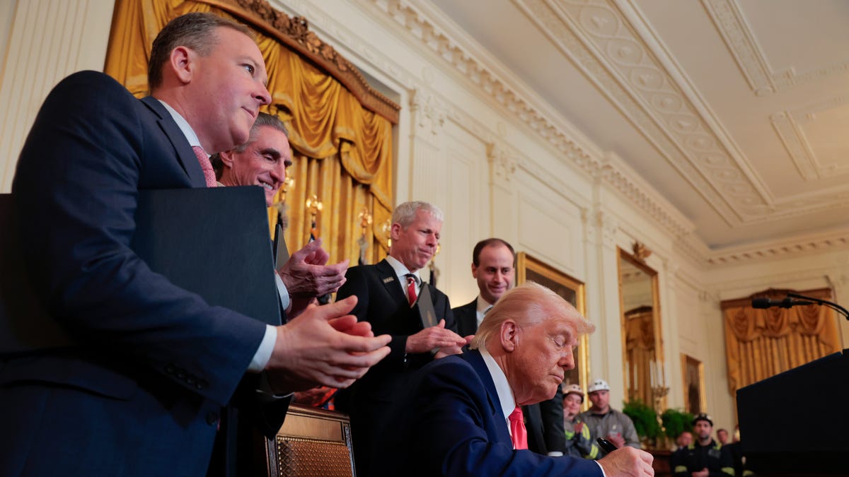 President Donald Trump signs a series of executive orders on American energy production and easing regulations on coal during a ceremony in the East Room of the White House on April 8, 2025, in Washington, D.C. The Trump administration has elected to roll back Biden-era environmental policies with the intention to help revive coal-fired plants in order to restore America's energy independence. Trump was joined by (L-R) EPA Administrator Lee Zeldin, Interior Secretary Doug Bergum, and   Energy Secretary Chris Wright.